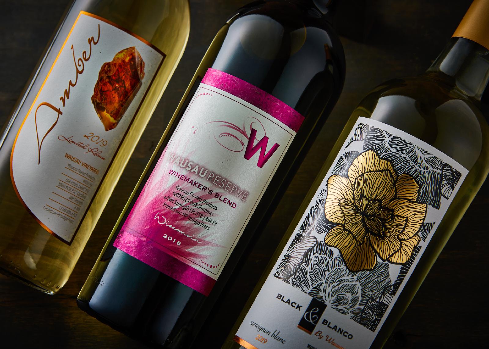 an assortment of wine bottles with different colors, textures, and shapes of labels from wausau coated